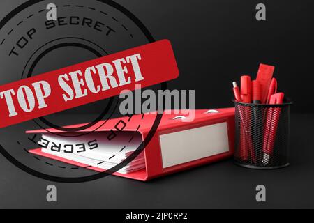 Folder with top secret documents on dark background Stock Photo