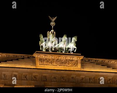 Quadriga on the Brandenburg Gate at night. The sculpture was designed by Johann Gottfried Schadow. The German culture in the capital city Berlin. Stock Photo
