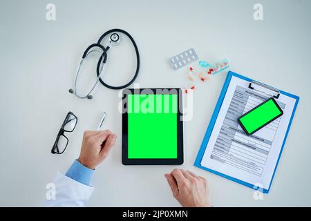 Technology helps make significant contributions to the improvement of healthcare. High angle shot of an unrecognizable doctor using a digital tablet Stock Photo