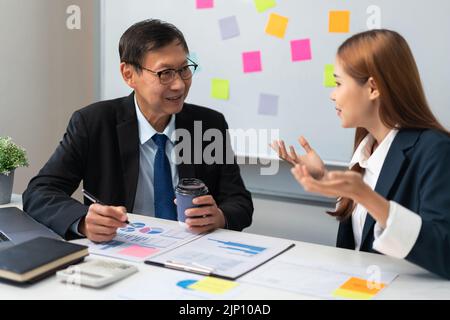 Business partnership concept, Confused businesswoman while discussing project with business senior. Stock Photo