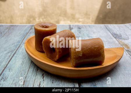 selective focus of brown sugar cubes in wooden tray Stock Photo