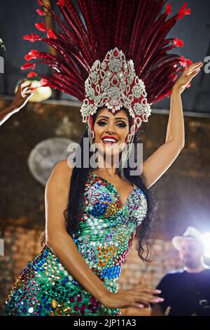 Female samba dancer in carnival dress posing with male spectator at ...