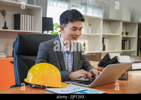 Portrait professional engineer smiles and looks in computers working with communication internet design project modern looking lifestyle background Stock Photo