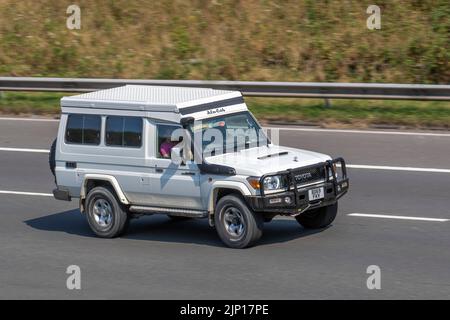 2018 white Toyota Landcruiser Station wagon; moving cars, being driven, in motion, travelling on the M6 motorway, UK Stock Photo