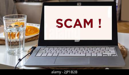Email spam blocking, phishing mail warning popup, network security concept. On a laptop at home with a warning window on the screen Stock Photo