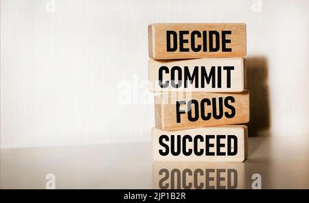 Motivational and inspirational quotes - Decide, commit, focus, succeed on wooden blocks and white background Stock Photo