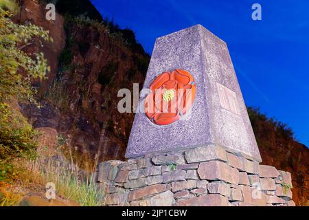 The Red Rose marker stone is at the border of Lancashire & Yorkshire on the M62 motorway & was opened by the Queen in 1971. Stock Photo