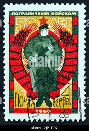 USSR - CIRCA 1968: A stamp printed in USSR issued for the 50th anniversary of Soviet Frontier Guards shows Frontier Guard, circa 1968. Stock Photo