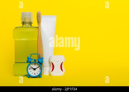 Mouthwash and other oral hygiene products on colored table top view with copy space. Flat lay. Dental hygiene. Oral care products and space for text o Stock Photo