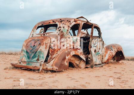 Vintage car abandoned and rusting in outback Australia Stock Photo