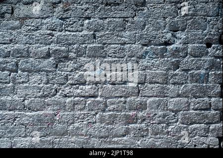 A brick wall sprayed with silver paint. Good for a background or texture Stock Photo