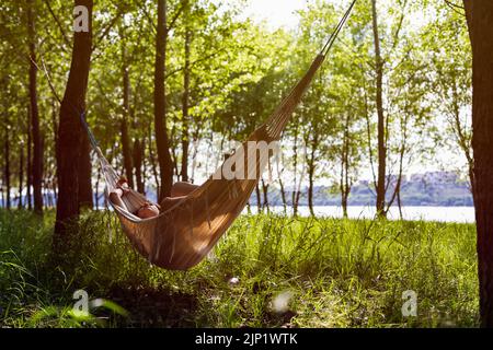 Women in hammock relaxing on the forest Stock Photo
