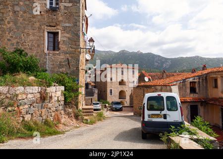 Olmeto, France - August 25, 2018: Street view with old houses and parked cars on a sunny summer day. Olmeto commune in the Corse-du-Sud department of Stock Photo