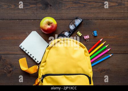 School bag with with colorful school items, top view Stock Photo