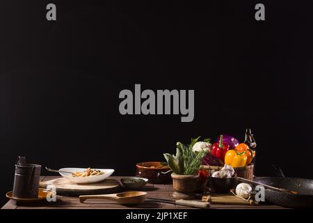 Dish of Italian pasta called Spaghetti and fresh Vegetables on the kitchen table of a restaurant kitchen Stock Photo