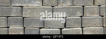 Regular shape blocks, texture, background. Paving slabs of gray blocks of flat shape, panorama. Pavement blocks in city park Stock Photo