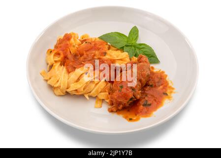 Egg pasta tagliatelle with tomato sauce and beef meat roll in white plate, typical recipe from Puglia, Italy, called braciola al sugo. isolated on whi Stock Photo