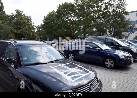 Berlin, Germany. 15th Aug, 2022. The hoods of several cars have been taped over after swastikas were scratched into the hoods of the cars. (to dpa 'More swastikas discovered on car hoods in Berlin') Credit: Carsten Koall/dpa/Alamy Live News Stock Photo
