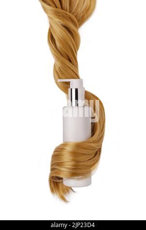 Shampoo bottle in hair lock isolated on white background. Natural cosmetic products for hair, mockup. Stock Photo