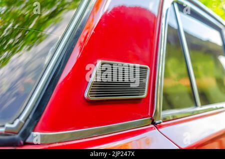 Ventilation from outside on Lada car. Close-up of ventilation grill on red car. Stock Photo