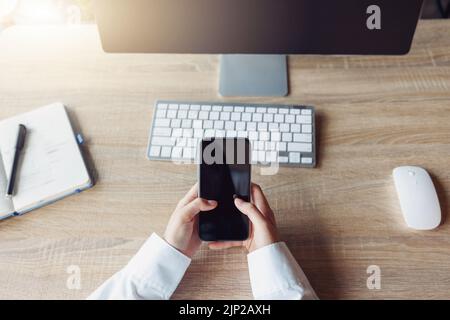 Top view of business woman hands holding phone while sitting in office on his workplace Stock Photo