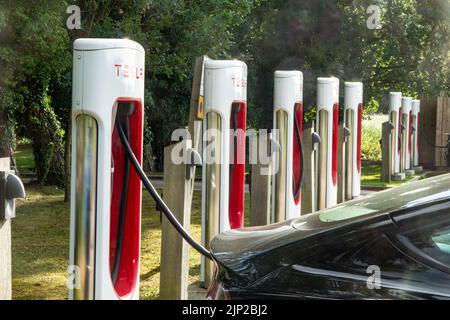 Tesla Electic Charging points in a car park In Thetford Forest, Norfolk Stock Photo