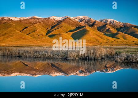 Pearl Peak massif in Ruby Mountains over Ruby Lake, East Marsh area, sunrise, Ruby Lake National Wildlife Refuge, Ruby Valley, Nevada, USA Stock Photo