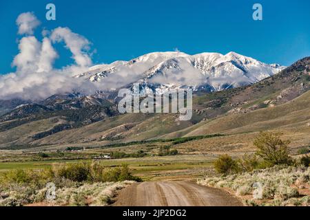 Pearl Peak massif in Ruby Mountains over Ruby Valley, after snow storm in late spring, view from Hastings Cutoff road, Nevada, USA Stock Photo