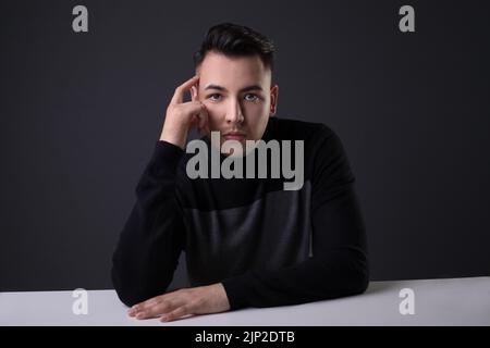 A handsome male in a studio thinking about something Stock Photo