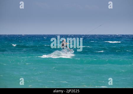 Man kitesurfing in the sea of Agiokampos beach , Greece Stock Photo