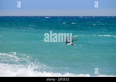 Man kitesurfing in the sea of Agiokampos beach , Greece Stock Photo