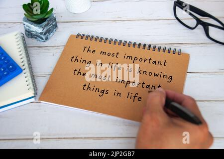 Motivational and inspirational quote about the most important thing in life. With hand writing on brown paper notepad. Motivational concept. Stock Photo