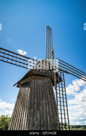 wooden windmill close-up with large blades with a beautiful sunny sky  Stock Photo