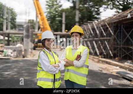 Portrait two engineer asian woman building contractors standing at construction site, Stock Photo