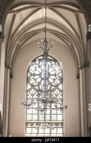 Bright interior of the church with stained-glass windows, view from below. Stock Photo