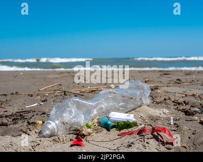Plastic waste lies on the beach Stock Photo