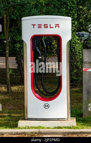 Tesla Electic Charging points in a car park In Thetford Forest, Norfolk Stock Photo