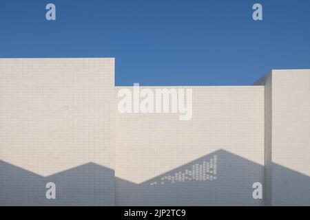 A closeup of Modern abstract white building facades under sun against blue sky Stock Photo
