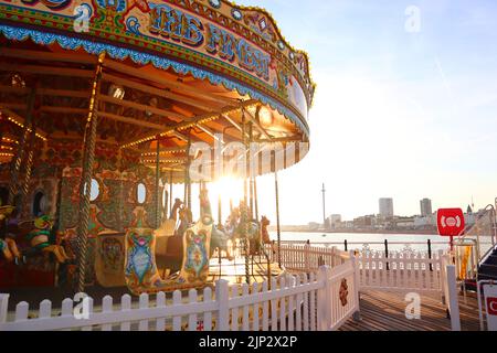 A merry-go-round attraction at the Brighton Palace Pier during the Brighton Pride, United Kingdom Stock Photo