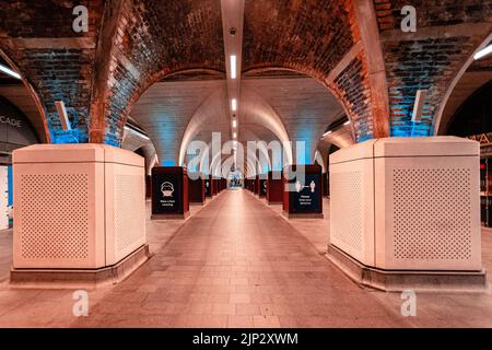 An empty illuminated underground station. London, United Kingdom. Stock Photo
