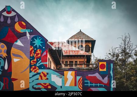 Beautiful graffiti on the old building in Bucharest on a cloudy day Stock Photo