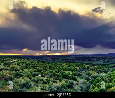 Dark cloud storm beam. Dramatic rainy sky over the tree field. Madrid Stock Photo