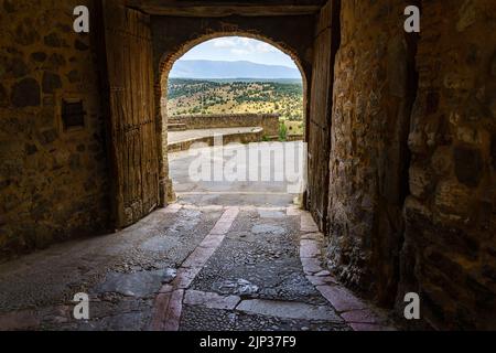 Pedraza Castle in Segovia. Old medieval palace of knights made of stone. Fortress with interior stone streets, green plants, arches and tunnels. Spain Stock Photo
