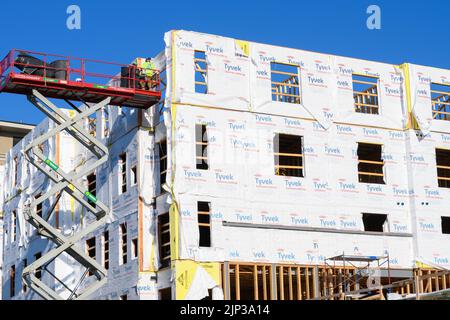 Construction in progress for a new apartment complex in downtown suburb. Stock Photo