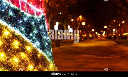 Christmas lights and decoration at night on the public street. Bright and vivid colors. Spain. Stock Photo