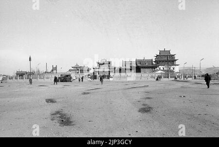 1960s, historical view of the the Gandan Monastery in Ulaanbaatar, Mongolia, Central Asia. The old Buddhist temple, the Janraiseg Temple is on the far right of the picture. The Monastery was started in 1809, when a school for the study of higher Buddhism separated from the Bogd Gegenov Monastery and was given the name Gandan, in honour of Gaden, a Tibetan Buddhist monastery. Stock Photo