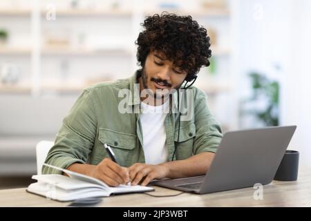 Young indian man having online training, home interior Stock Photo