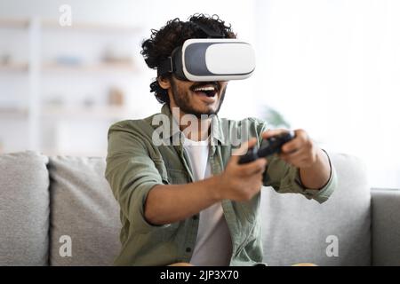 Young man trying virtual reality, playing video games Stock Photo