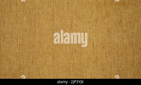 Background texture of burlap or canvas fabric in brown or ocher color close-up Stock Photo