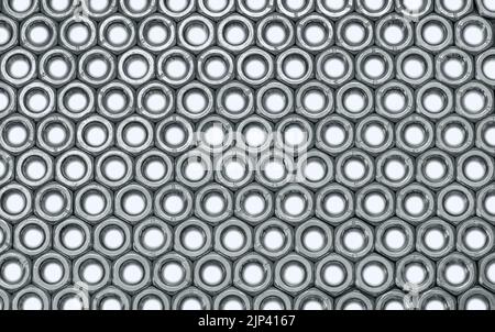 Metal nuts in a row background Stock Photo